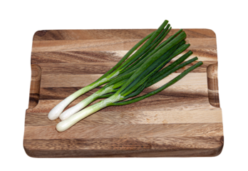 Fresh green onions on cutting board