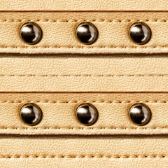 Seamless 4k photo texture material of golden colored leather surface with rivets.