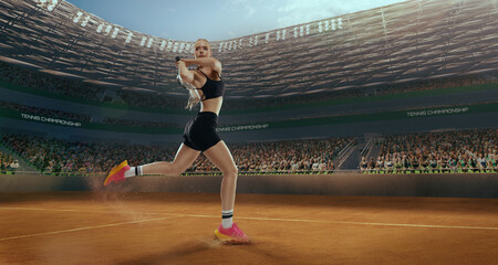 Woman tennis player playing tennis in professional tennis stadium.
