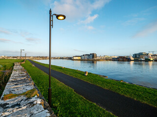 View from Nimmos Pier on river Corrib and the Long walk area. High tide. Blue cloudy sky....