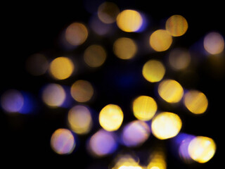 Abstract bokeh scene. Golden and blue glowing light leaks on black color background for design....