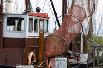 Fishing Boat with Nets and Life Rings at Dock