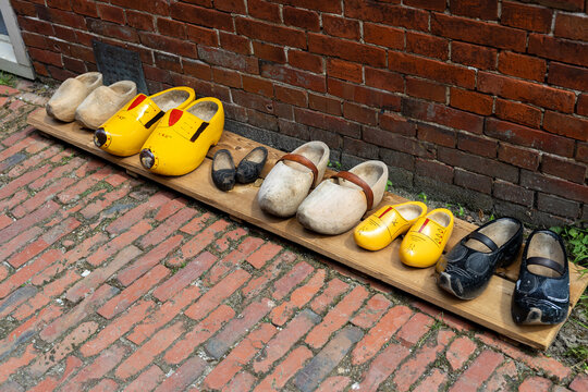 Assorted Traditional Dutch Wooden Clogs Displayed on Brick Pavement