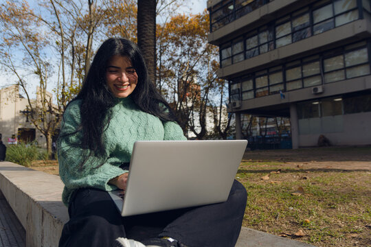 Young Venezuelan student in the University Square with her laptop