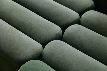 Minimalist upholstered textured, soft green cylindrical pattern, close-up