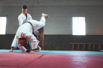 Teenage Boy Practicing Karate with His Father and Instructor