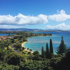 Fototapeta premium High-angle view of a coastal town nestled between turquoise water and lush greenery, under a vibrant blue sky