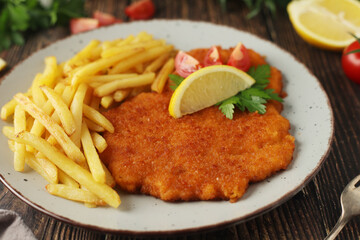 A Viennese schnizel with french fries	