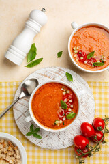 Spanish cool soup Andalusian gazpacho with basil, is a cold soup made of raw, blended vegetables, tomatoes, bell pepper,  cucumber, vinegar, garlic and stale bread. Directly above, vertical.