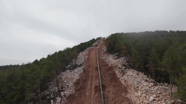 mountain construction drone view coniferous forest 4k. construction of gas pipelines in the mountains