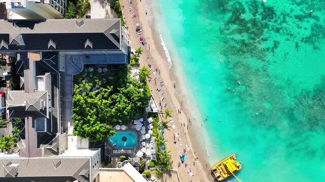 Slow Flyover Bird's Eye view of Waikiki Beach and Kalakaua Ave in the morning