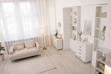 Stylish living room interior. Sofa, dresser, shelving unit and other furniture indoors, above view