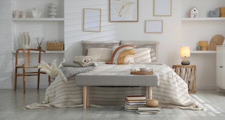 Comfortable bed with soft linens in room. Home textile