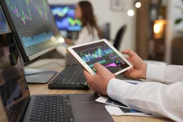 Stock exchange. Man working at desk in office, closeup