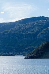 Fototapeta premium Lake Como and mountains under a clear blue sky.