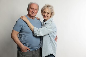 Portrait of lovely senior couple on white background
