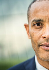 Middle aged business man entrepreneur looking at camera outside - Confident businessman wearing suit standing in front of office building - Vertical photo