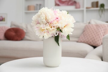 Bouquet of beautiful peonies on table indoors