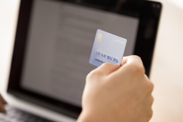 Close up shot person client hand hold credit card before notebook screen. Ecommerce online shopping digital payment security mobile bank paying for subscription services financial transaction concept
