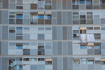 Geometric frontal view of the shutters and balconies of an urban building