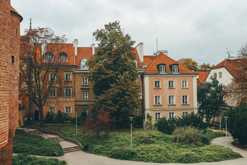 view of pedestrian street with living houses facades in warsaw with green vegetation