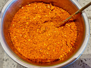 chili powder in a bowl, top view.