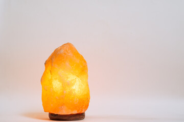 Himalayan salt lamp on white background with copy space.