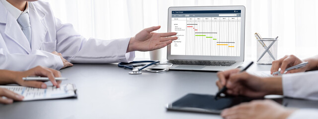 Project planning software for brisk business project management on the computer screen showing...