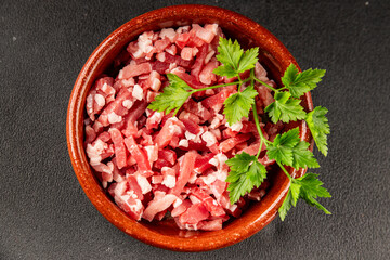 Bacon cubes smoked chopped meat small pieces fresh delicious gourmet food background on table rustic food top view copy space