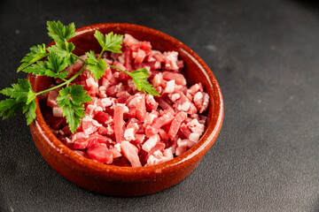Bacon cubes smoked chopped meat small pieces fresh delicious gourmet food background on table rustic food top view copy space