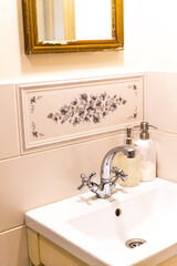 faucet and sink in a bright Provence style bathroom