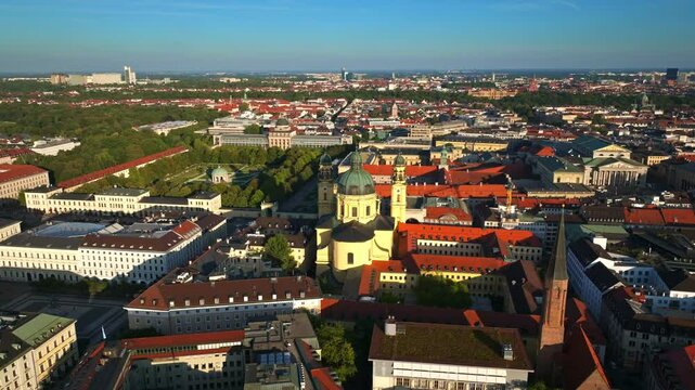 Aerial view of the Theatine Church (Theatinerkirche) in Munich, Germany, a striking Baroque-style Catholic church with twin towers and a bright yellow fa&ccedil;ade near Odeonsplatz. 30 September 2024.