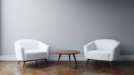 Two white armchairs flank a small wooden table in a simple, minimalist room