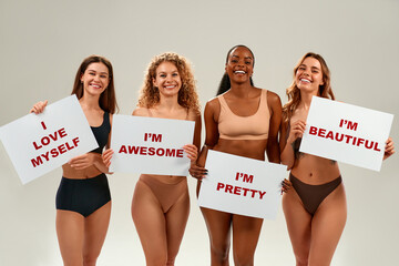 Diverse women holding self-love signs promoting body positivity and confidence