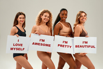 Diverse women holding self-love signs promoting body positivity and confidence