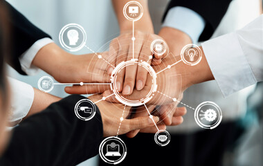A group of diverse hands coming together symbolize collaboration and innovation in a modern...