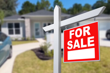 Home For Sale Real Estate Sign and Beautiful New House.