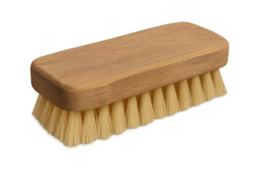 Natural-bristled wooden cleaning brush resting on transparent surface, ready for home cleaning tasks