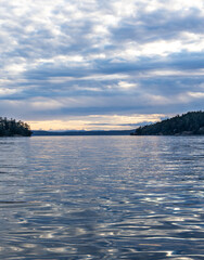 Waters of the San Juan Islands reflect beautiful colors in the sky creating a magical landscape as...