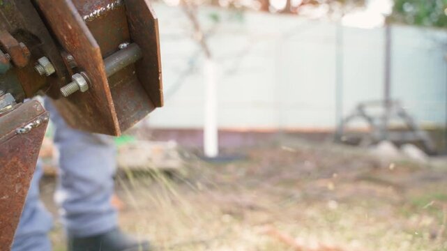 Wood chips flying out of a wood chipper, close-up in slow motion 