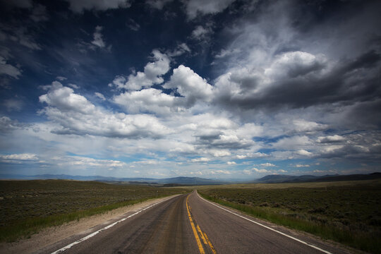 Montana, Big Sky Country with dramatic clouds over back country road