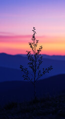 Solitary Tree Silhouette Against Orange Sunset Sky and Mountains. Mobile wallpaper. Virticle image. AI generated.