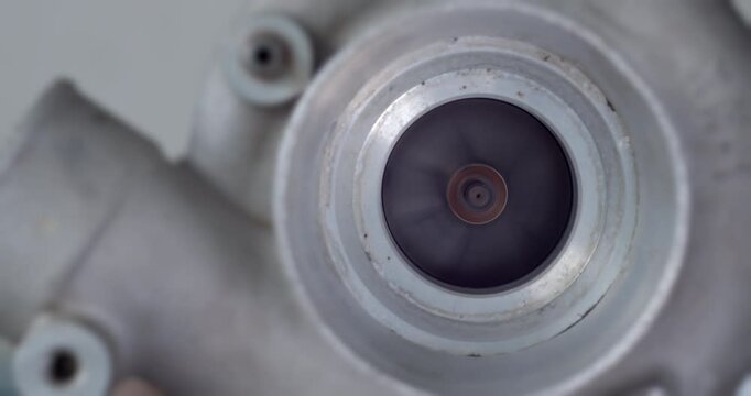 Front-facing close-up view of a turbocharger blade rotating quickly, capturing the mechanical beauty and engineering precision of forced induction systems.