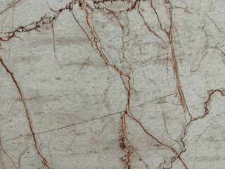 Intricate cracks weave across a weathered concrete surface, creating a fascinating display of...