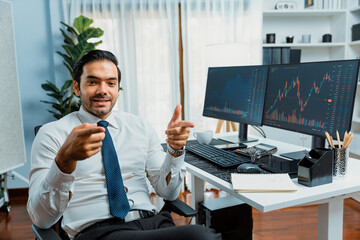 Profile of successful in trader businessman looking at camera with two stock exchange investment...