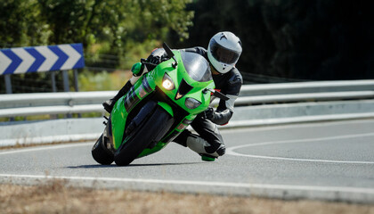 Professional motorcyclist leaning into a curve on a sport bike during a race