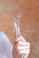 Female holding internet network cables connectors in her hand