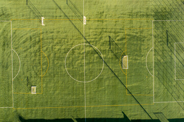 local community football field aerial overview, aerial top down view of empty soccer field with...