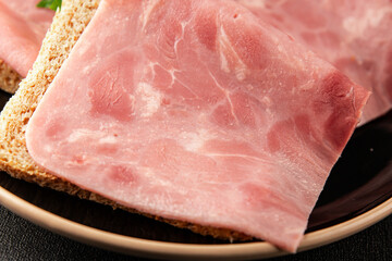 Ham slices meat spam pork fresh delicious gourmet food background on the table rustic food top view...