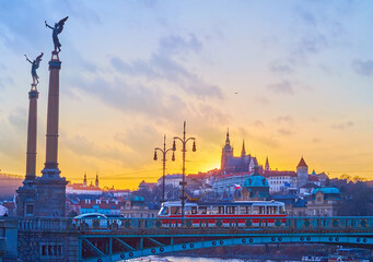 Fototapeta premium High columns with sculptures on Svatopluk Cech Bridge in Prague, Czechia
